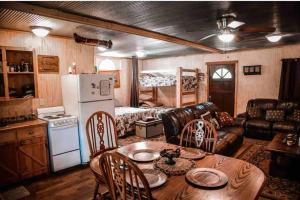 a living room with a couch and a table with chairs at Liberty Cabin on Collier Creek in Norman