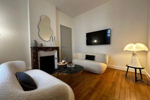 a living room with a couch and a fire place at In the beautiful districts of Tours a "particular" with great comfort in Tours