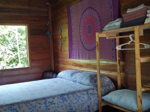 a bedroom with two bunk beds and a window at Recanto Shanti in Alter do Chao