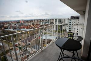 a balcony with a table and a view of a city at Sunrise Apartment in Oradea