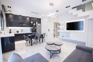 a living room with a couch and a table at RAFAELA SUITES in Flogita
