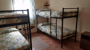 a room with three bunk beds in a room at Brezza di Mare in Calasetta