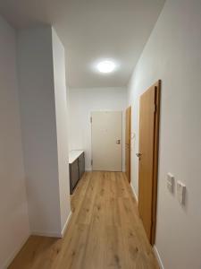 an empty hallway of an apartment with white walls and wooden floors at Wohnung in Nürtingen in Nürtingen