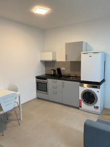 a kitchen with a washing machine and a washer at Wohnung in Nürtingen in Nürtingen