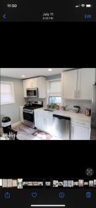 a kitchen with white cabinets and a stove top oven at Beautiful master bedroom with private bathroom in Baltimore