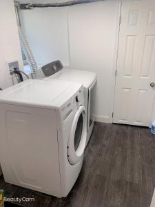 a white washing machine in a room with a door at Beautiful master bedroom with private bathroom in Baltimore