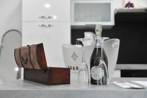 a couple of glass bottles sitting on a counter at Apartman Lucia in Đakovo