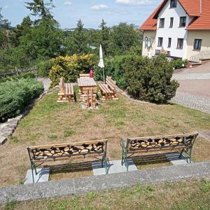 a group of benches sitting in a park at Hotel Prox in Arnstadt