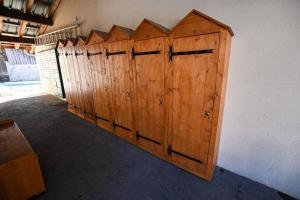 a row of wooden doors on a wall at Le balcon des neiges in Praz-sur-Arly