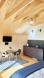 a kitchen and dining room with a table and chairs at Dzikie Lisko - Apartament z klimatyzacją in Lesko