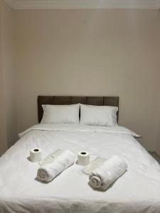 a bed with two rolls of towels and two cups on it at Taksim 41 - number 8 in Istanbul