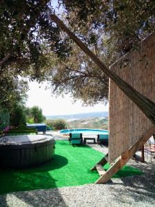 a backyard with a picnic table and a pool at Treehouse ,Casa Arbol, with Spa in Algarrobo