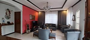 una sala de estar con sofás y una lámpara de araña. en Donsol Aguluz Homestay, en Donsol