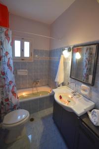 een badkamer met een toilet, een wastafel en een bad bij Giannis and Fridas Garden in Sidari
