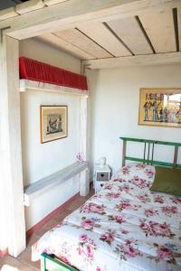 Un dormitorio con una cama con flores. en Antico Casello *un'oasi di pace a Sansepolcro* en Sansepolcro