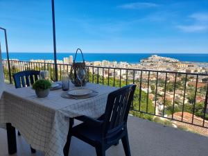 a table on a balcony with a view of the ocean at Apartamentos Serenity in Peniscola