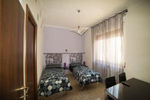a bedroom with two beds and a window at Villa Elena in Montesilvano