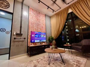 a living room with a tv and a table at UrbanRuma#Industrial#Putrajaya#500Mbps#Netflix in Putrajaya