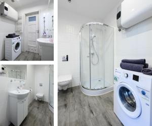 a bathroom with a shower toilet and a washing machine at Studio Mandoria in Łódź