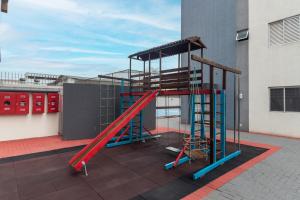 a playground on the roof of a building at Family Space Curitiba/vaga de garagem Gratis in Curitiba