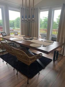 a dining room table with chairs in a room with windows at The Lodge at Haggerston Castle in Beal