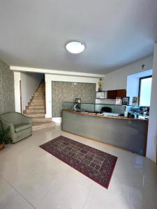 a living room with a kitchen and a staircase at Hotel d'Orleans in Palermo