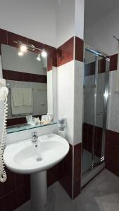 a bathroom with a sink and a shower at Hotel d'Orleans in Palermo