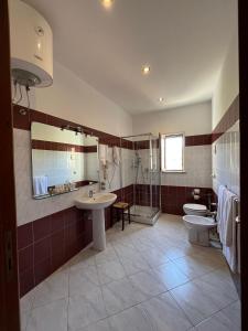 a bathroom with two toilets and a shower and a sink at Hotel d'Orleans in Palermo