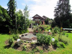 a garden with flowers and a house in the background at Haus Tanneck, Nr 5 in Kellenhusen