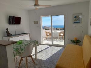 a living room with a table and a view of the ocean at Apartamentos Panoramica in Peniscola