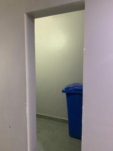 a hallway with a blue trash can in a room at B70 HC Rental Apartment at TK Central with Swimming Pool & Gyms in Phnom Penh