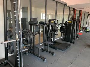 a gym with a row of treadmills and machines at B70 HC Rental Apartment at TK Central with Swimming Pool & Gyms in Phnom Penh