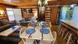 a wooden table in a living room with a table and chairs at Rustic Cabin in Sevierville