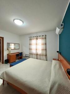 a bedroom with a large bed and a window at Hotel d'Orleans in Palermo