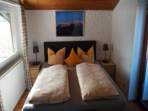 a bedroom with a bed with two pillows on it at Gästehaus München in Schönau am Königssee