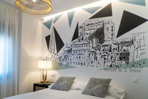 a bedroom with a drawing on the wall at Cervantes5Collection Delux Alcazar in Toledo
