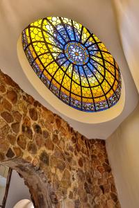 a stained glass window on the ceiling of a building at MacLeod House Guest Cottage in Kloof +33 photos
