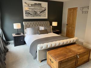 um quarto com uma cama grande e uma mesa de madeira em Luxurious Victorian villa with parking sleeps six em Bury Saint Edmunds