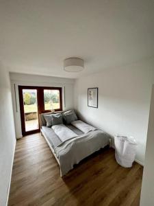 a bedroom with a bed in the corner of a room at Wohnglück Seifferer in Ravensburg