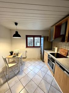 a kitchen with a table and a table and a table and a table at Wohnglück Seifferer in Ravensburg