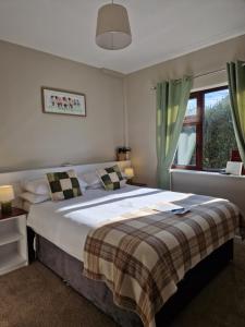 Un dormitorio con una cama grande y una ventana en Churchfield B&B, en Doolin