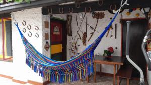 a hammock is hanging outside of a building at Apartaestudio tipo cabaña in Bogotá
