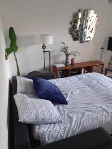 a bedroom with a bed with a blue pillow at Studio Terrasse Proche Palais des Festivals in Cannes