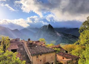 a view of a mountain with a town and buildings at Chasteuil Locations Studio in Castellane