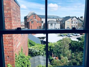 a view of a city from a window at Three Warehouse Apartments in Ulverston