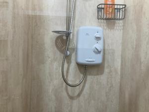 a soap dispenser on the wall of a bathroom at Hillview, Ground floor apartment, Largs in Largs