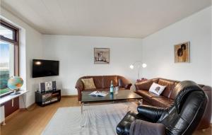 a living room with a leather couch and a table at 3 Bedroom Beautiful Home In Haderslev in Haderslev