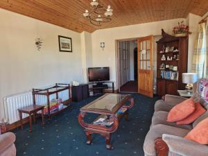 a living room with a couch and a table at Churchfield B&B in Doolin