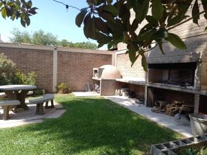 a backyard with a fireplace and a picnic table at 1780 Alojamiento in Guaymallen