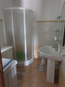 a bathroom with a shower and a sink and a toilet at Charming Casa Vista Verde, stunning valley views. in Alghero